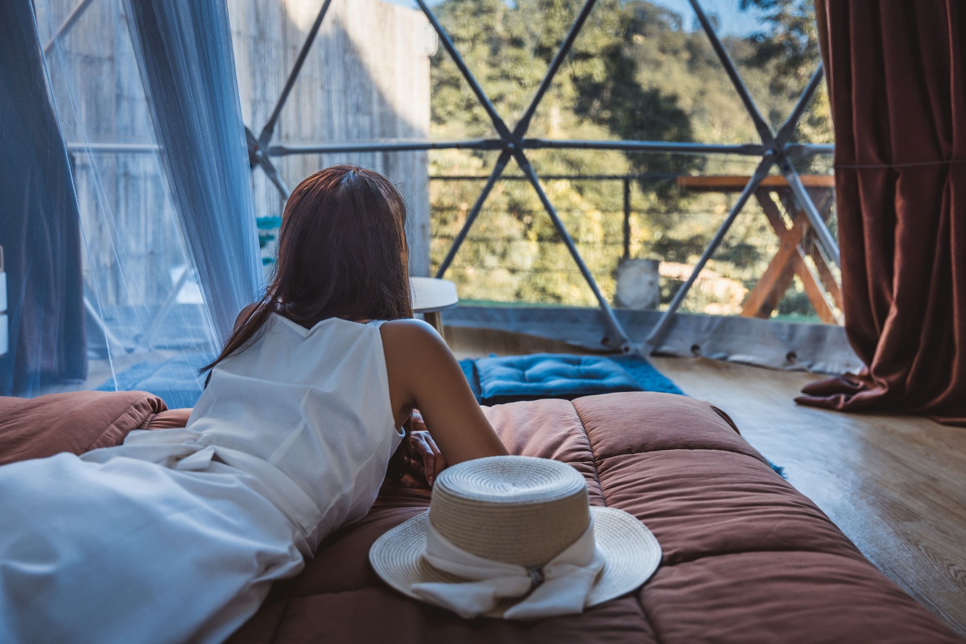 Travel woman relax inside a luxury camping dome tent
